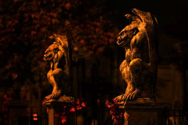 Two guardian gargoyles at haunted house clipart