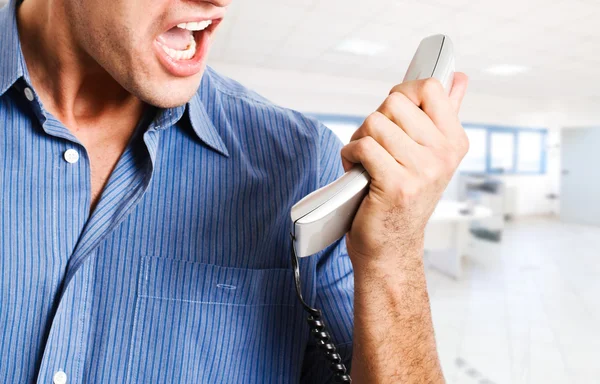 Businessman screaming at the phone — Stock Photo, Image