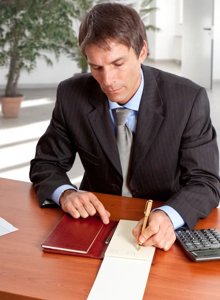 Businessman working on his desk Stock Picture