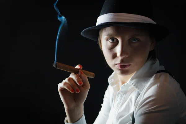 Woman in black hat with cigar in isolated — Stock Photo, Image