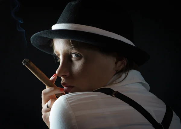 Woman in black hat with cigar in black isolated — Stock Photo, Image