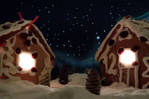 Снежный имбирный домик со звездами на заднем плане — стоковое фото