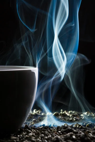 Cup with tea and smoke — Stock Photo, Image