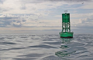 Navigational buoy in calm seas with clouds clipart