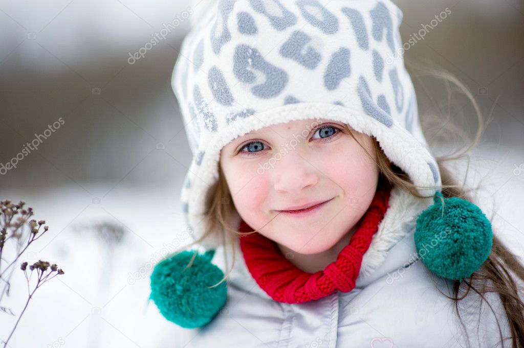 Winter portrait of adorable smiling child girl