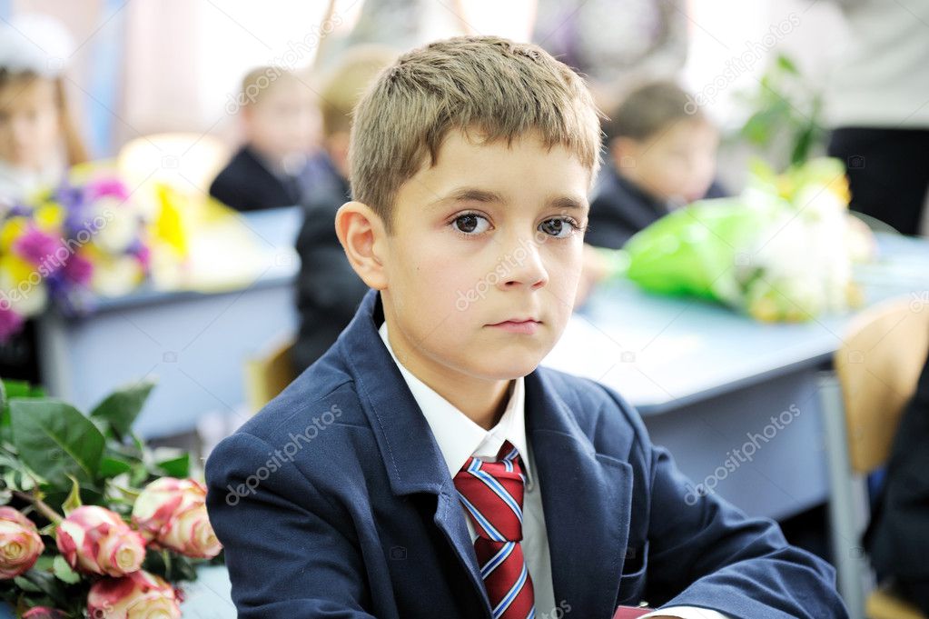 Portrait of first-grader boy sitting at his desk