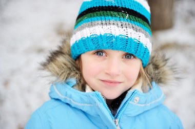 Little child girl posing outdoors in winter outfit clipart