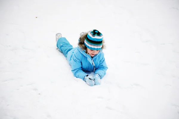 Маленькая девочка веселится в снегу — стоковое фото