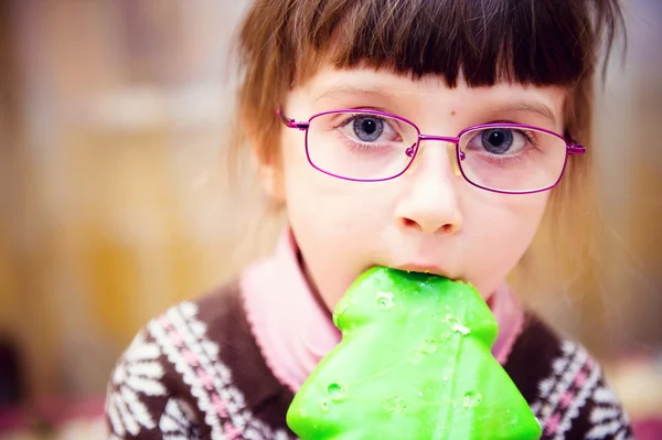 Portrait of child girl biting gingerbread — Stock Photo, Image