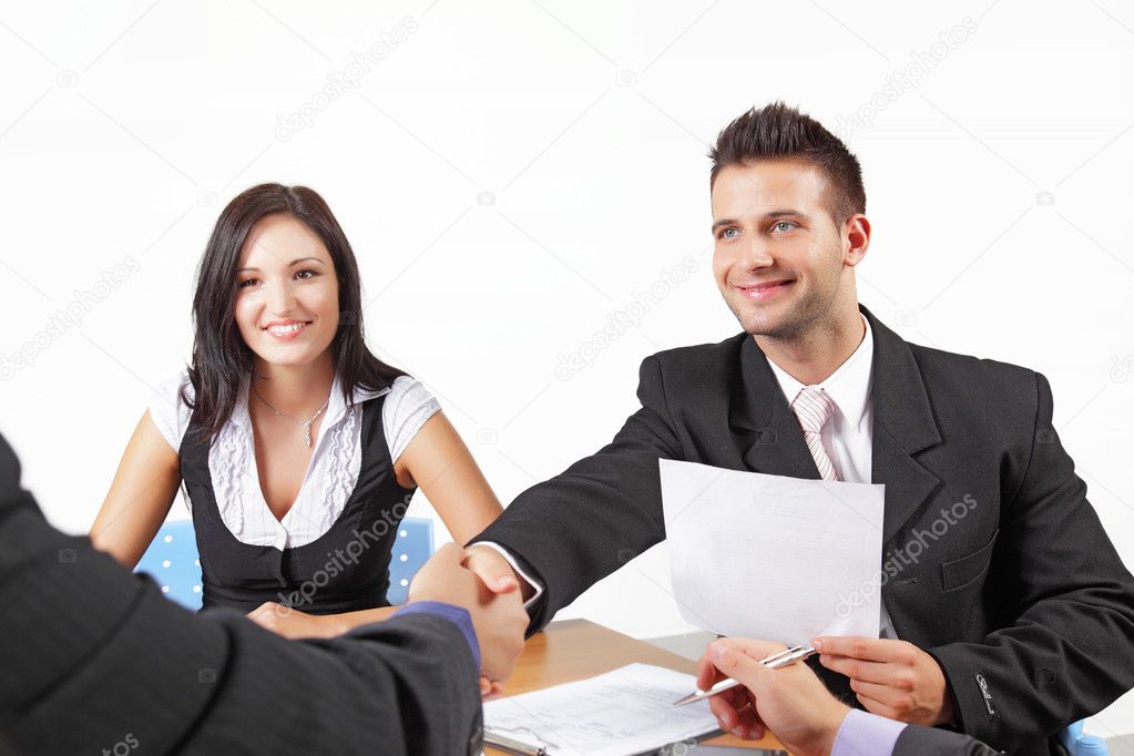 Businesspeople shaking hands in a meeting
