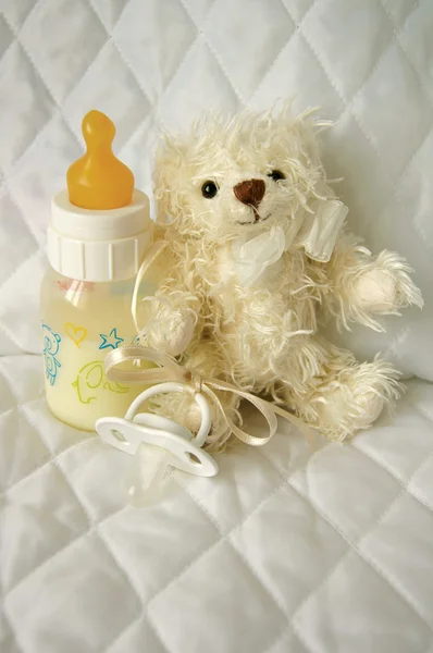 Teddy bear and bottle with milk — Stock Photo, Image
