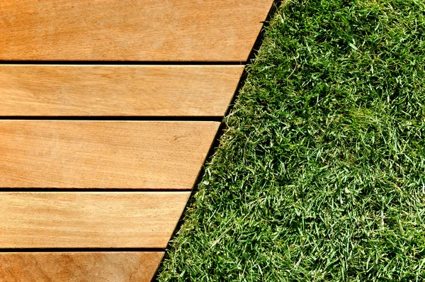 stock image Wood and grass divided by a diagonal