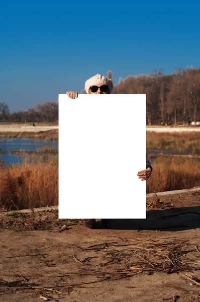 Girl with a poster on the nature — Stock Photo, Image