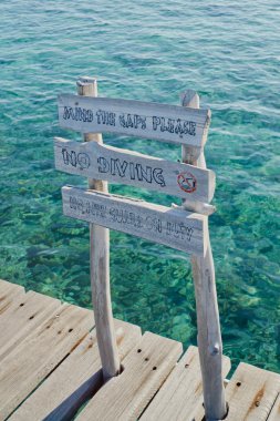 Danger wooden sign on Maldivian jetty clipart