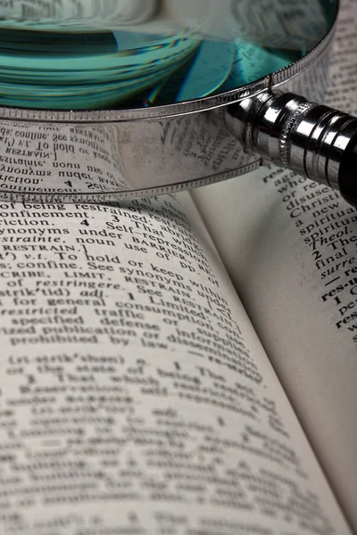 Magnifer and dictionary — Stock Photo, Image