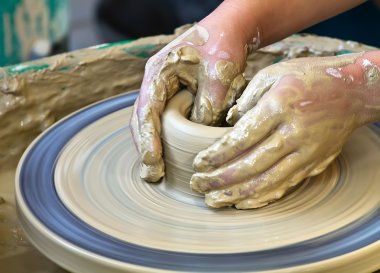 Hands working on pottery clipart