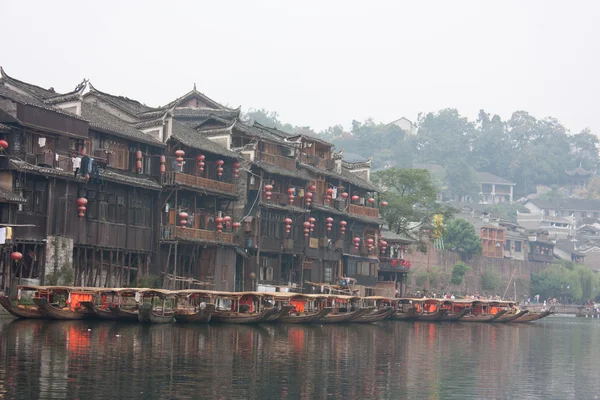 stock image Boats and wooden houses at Phoenix Town, China