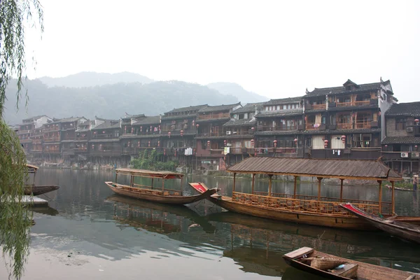 stock image Boats and wooden houses at Phoenix Town, China