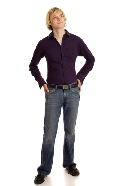 Jonge man in een bruin shirt en spijkerbroek. studio opname over Wit. — Stockfoto