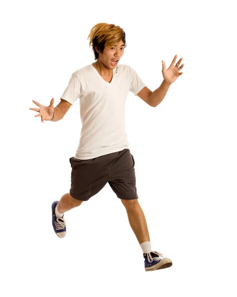 Junger Mann springt. Studioaufnahme über Weiß. — Stockfoto