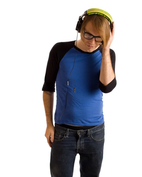 Young man listening to headphones. Studio shot over white. — Stock Photo, Image