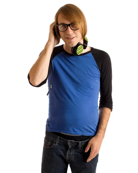 Young man listening to headphones. Studio shot over white. — Stock Photo, Image