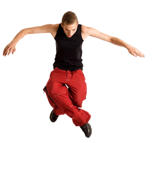Junger Mann springt. Studioaufnahme über Weiß. Stockbild