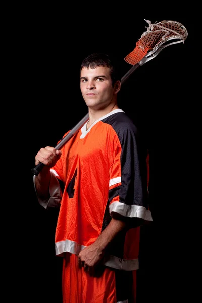 Male lacrosse player. Studio shot over black. — Stock Photo, Image