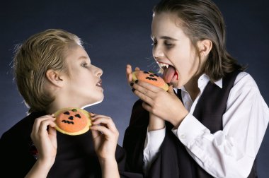 Boys eating Halloween cookies clipart