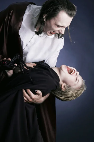 Adult vampire and his young victim — Stock Photo, Image