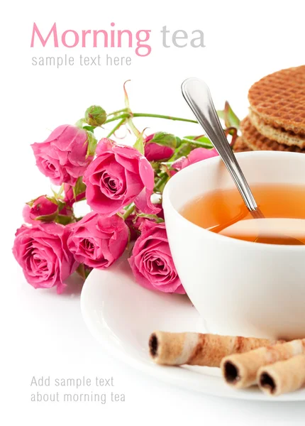 stock image Tea in cup with biscuits and bouquet roses