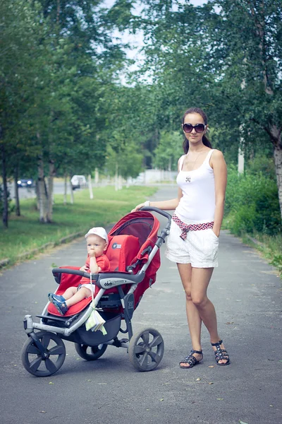Mother with a baby in stroller — Stock Photo, Image