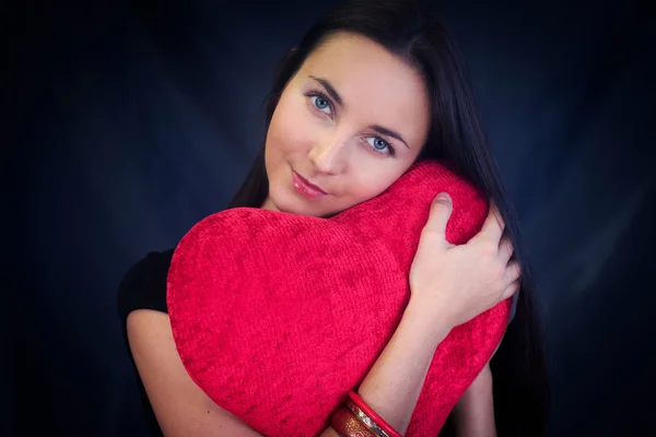 stock image Woman with heart shaped cushion