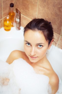 Woman in bathtub full of foam