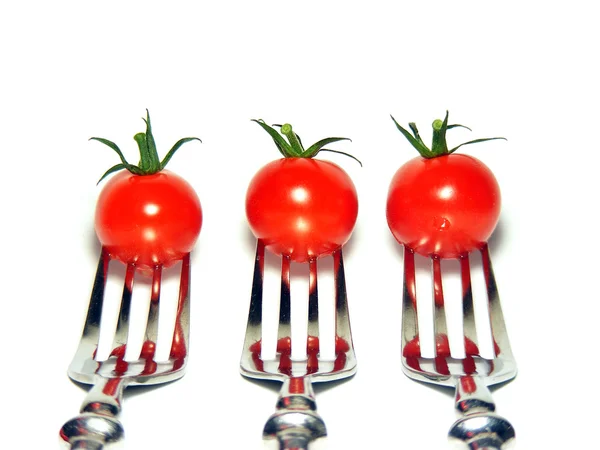 3 Tomates cherry en tenedores de plata Imagen De Stock