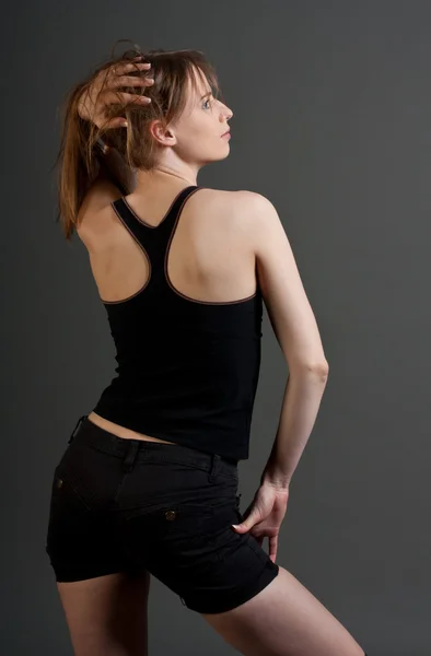 Stock image Young fitness woman from back