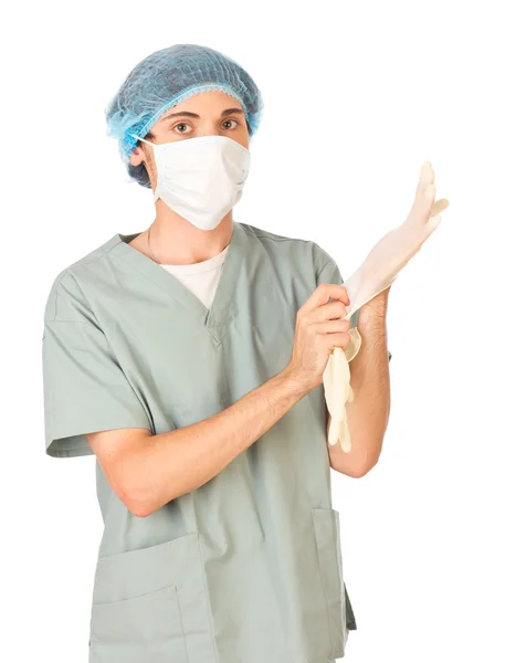 Joven trabajador médico poniéndose guantes — Foto de Stock
