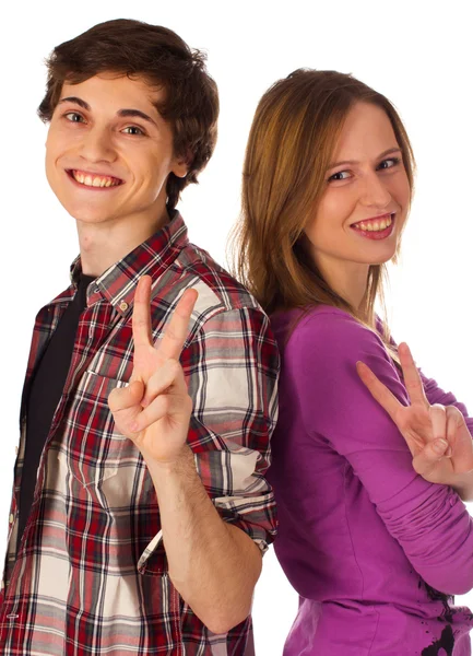 Young couple standing and showing victory gesture Stock Image