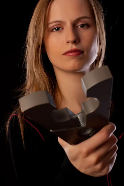 Serious young woman threatens you by huge pin — Stock Photo, Image