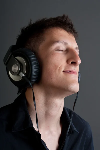 stock image Young male person listening to music