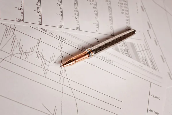 Pen and financial charts Royalty Free Stock Photos