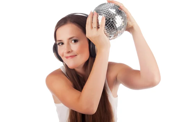Girl in headphones and with a sphere in hands — Stock Photo, Image
