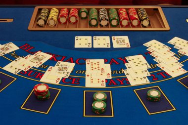 Blackjack table in casino with cards clipart