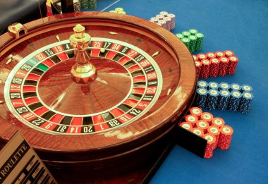 Roulette table in casino with chips close-up clipart