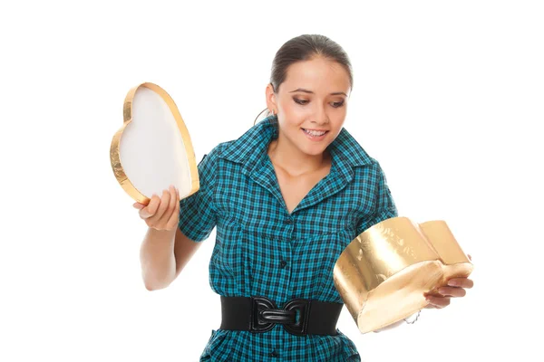 Cute young woman looking into gold box gift as heart — Stock Photo, Image