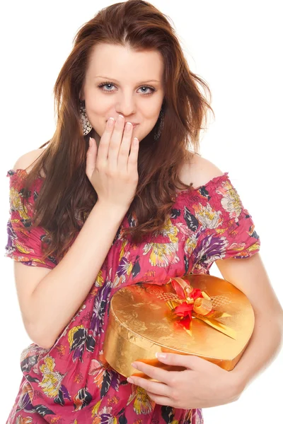 Surprised young woman with gift gold box as heart — Stock Photo, Image