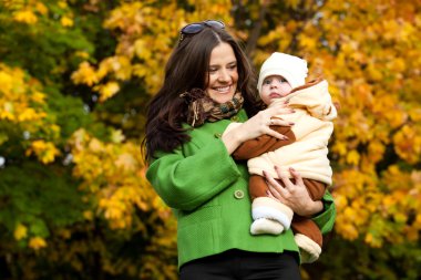 Young mother with baby in arms up clipart