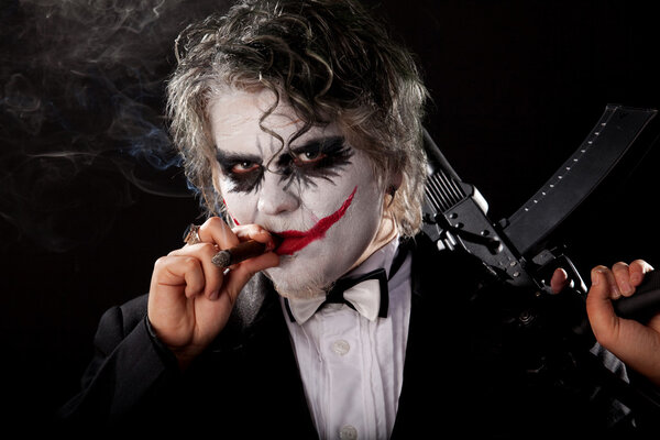 Bad joker with submachine gun and cigar