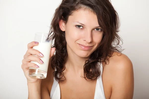 Young woman holding glass of milk — Stock Photo, Image