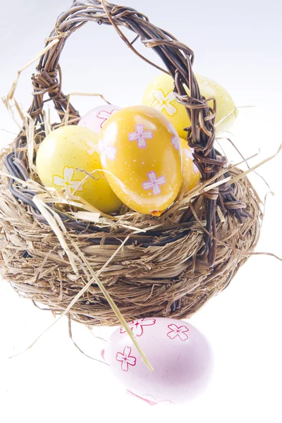 Easter Eggs in a bast basket — Stock Photo, Image